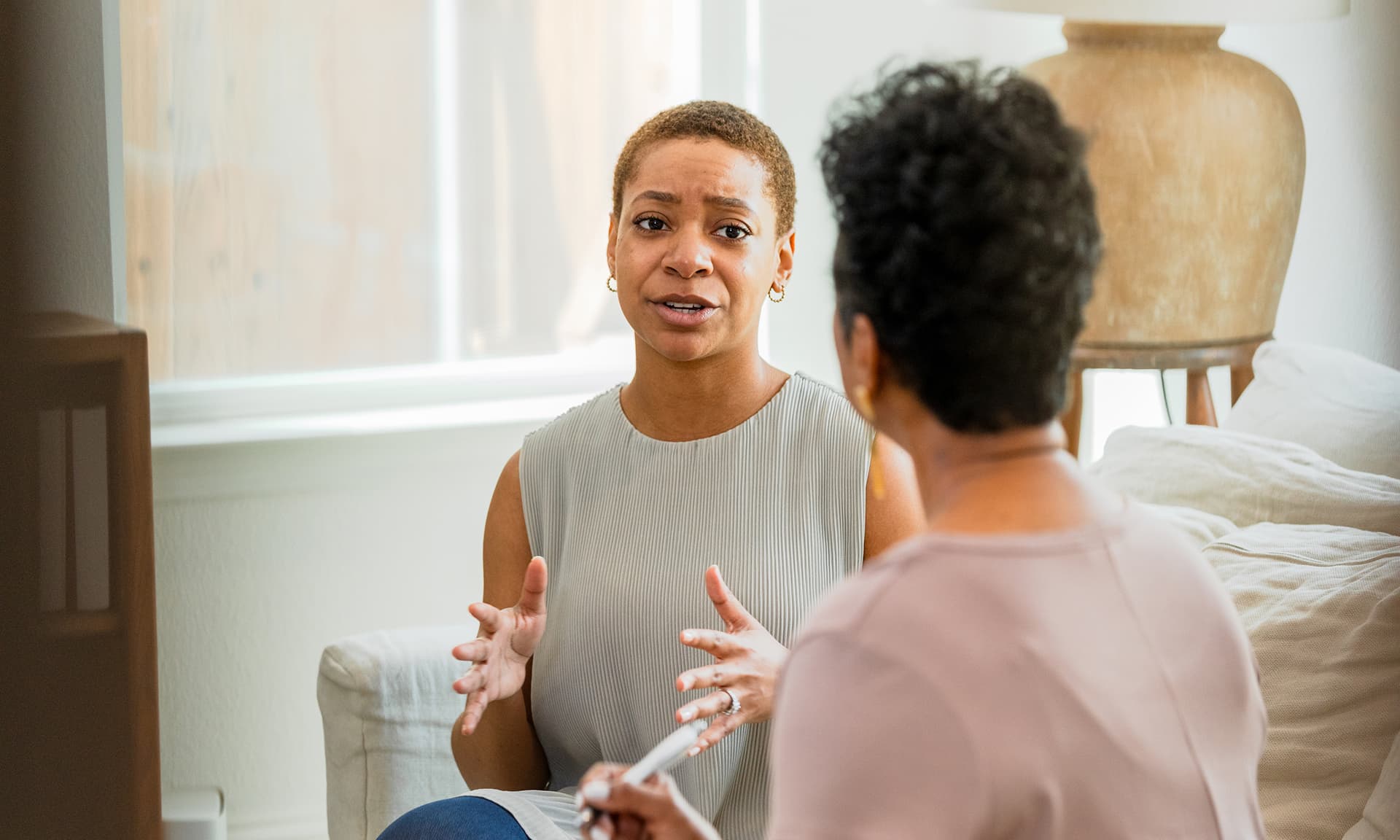 Millennial woman having conversation with older woman