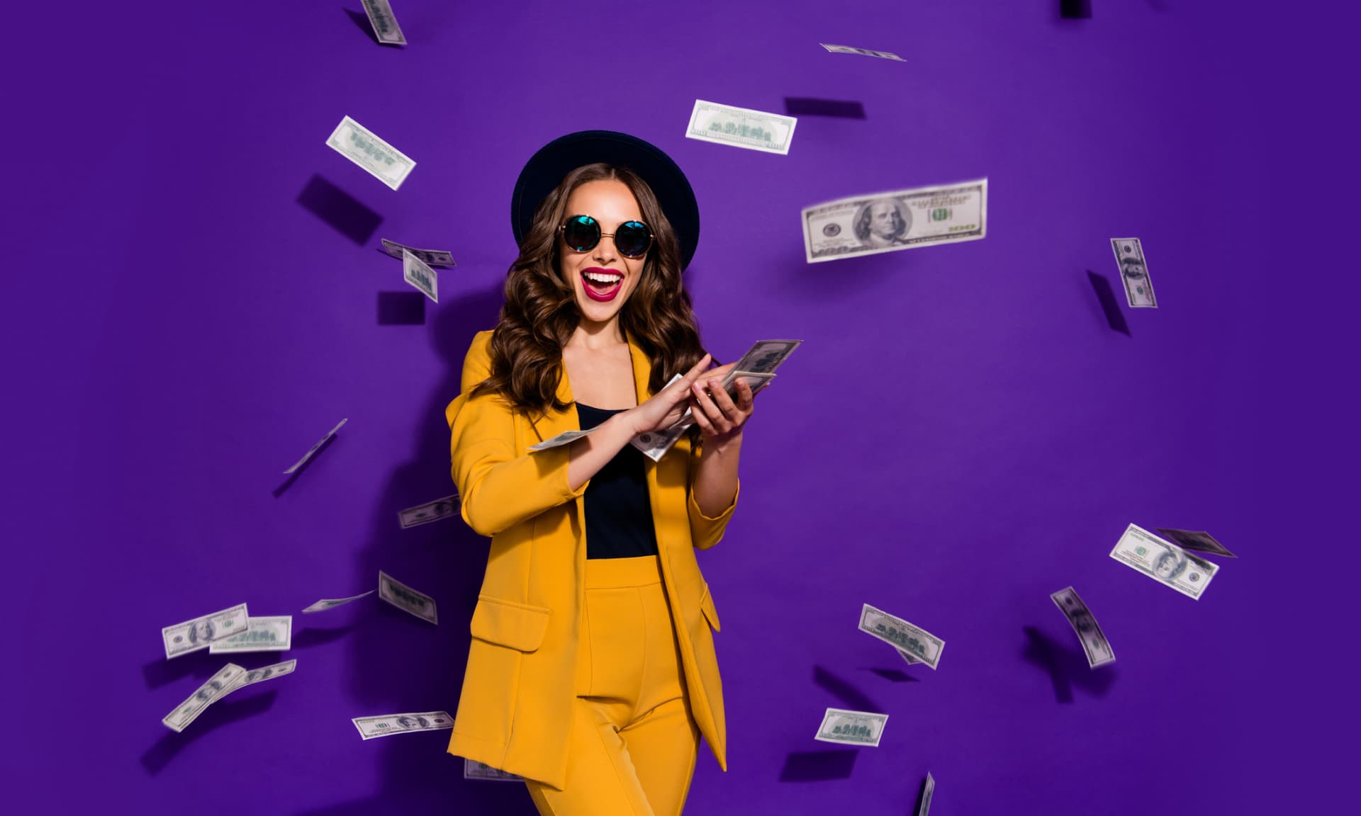 happy woman surrounded by cash falling from sky