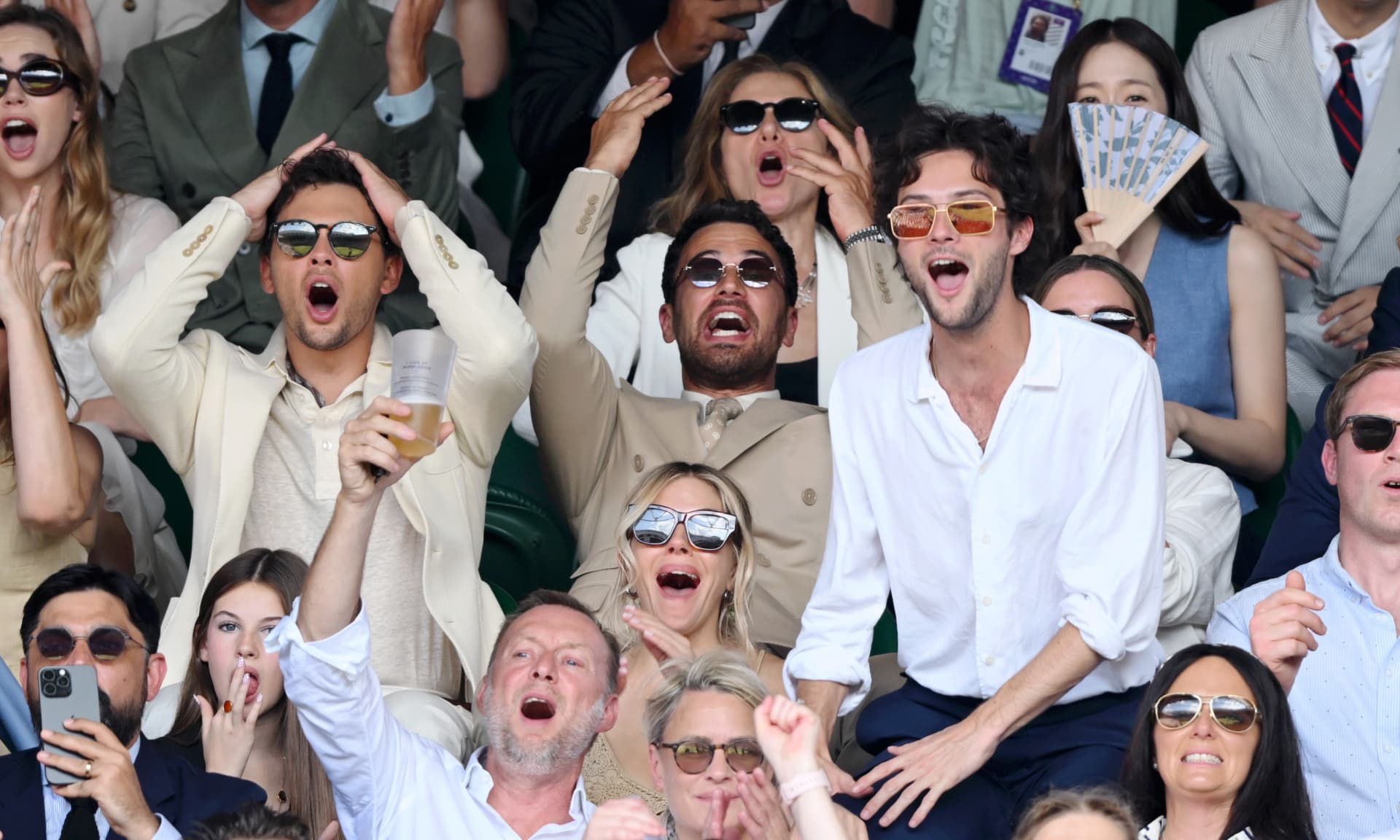 Cooper Koch, Sienna Miller, Theo James and Oli Green react at Wimbledon