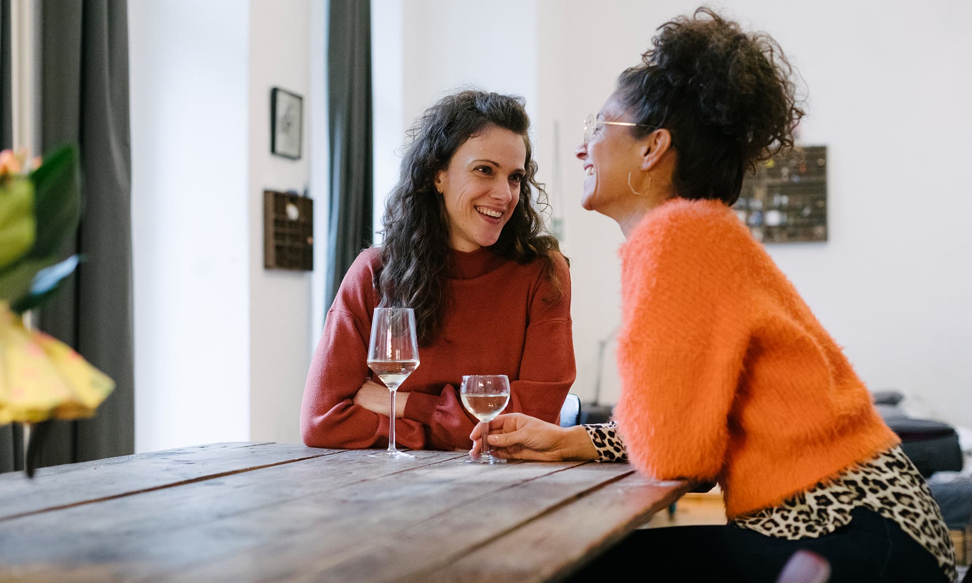Two women talking over drinks